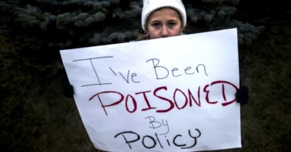 Ahmirah Porter, 9, of Flint stands outside City Hall to protest Michigan Gov. Rick Snyder&#039;s handling of the water crisis.