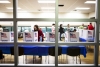 A polling official straightens up the voting booths during the US mid-term elections in McLean, Virginia on November 4, 2014.