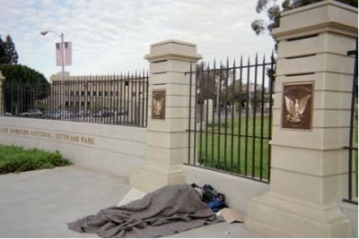 A homeless individual sleeps outside the V.A.&#039;s West L.A. campus