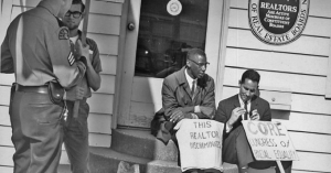 Partcipants of a fair housing protest that took place in Seattle in 1964. The Fair Housing Act was signed by LBJ just four years later, in 1968, in the wake of Martin Luther King Jr.&#039;s assassination. Now, advocates worry the law is under threat. 