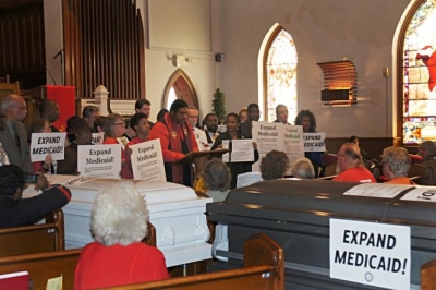 The N.C. NAACP held a mock funeral this week to dramatize the effect of the state&#039;s refusal to expand Medicaid to 500,000 residents. The next day, N.C. House Speaker and U.S. Senate candidate Thom Tillis -- an outspoken opponent of Medicaid expansion -- said the state should consider it.